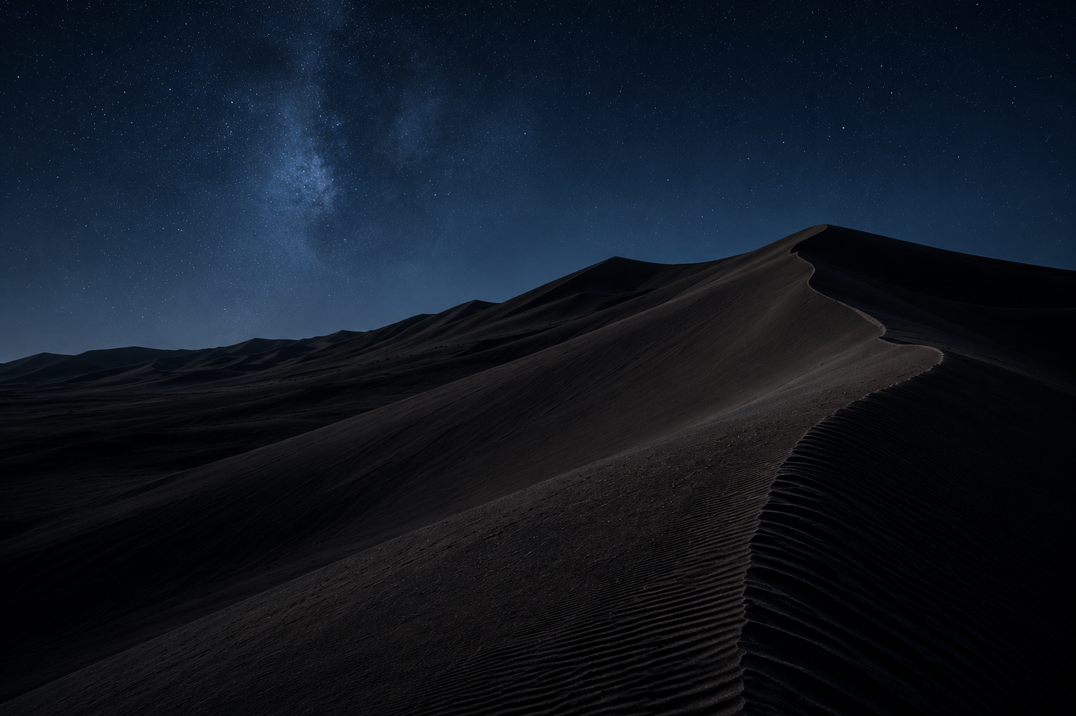 A lone oryx crossing beneath a towering red dune at golden hour