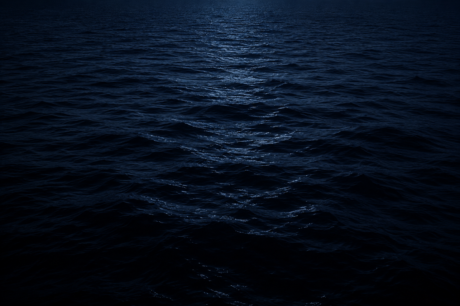 A single sailboat carving a wake across deep blue water
